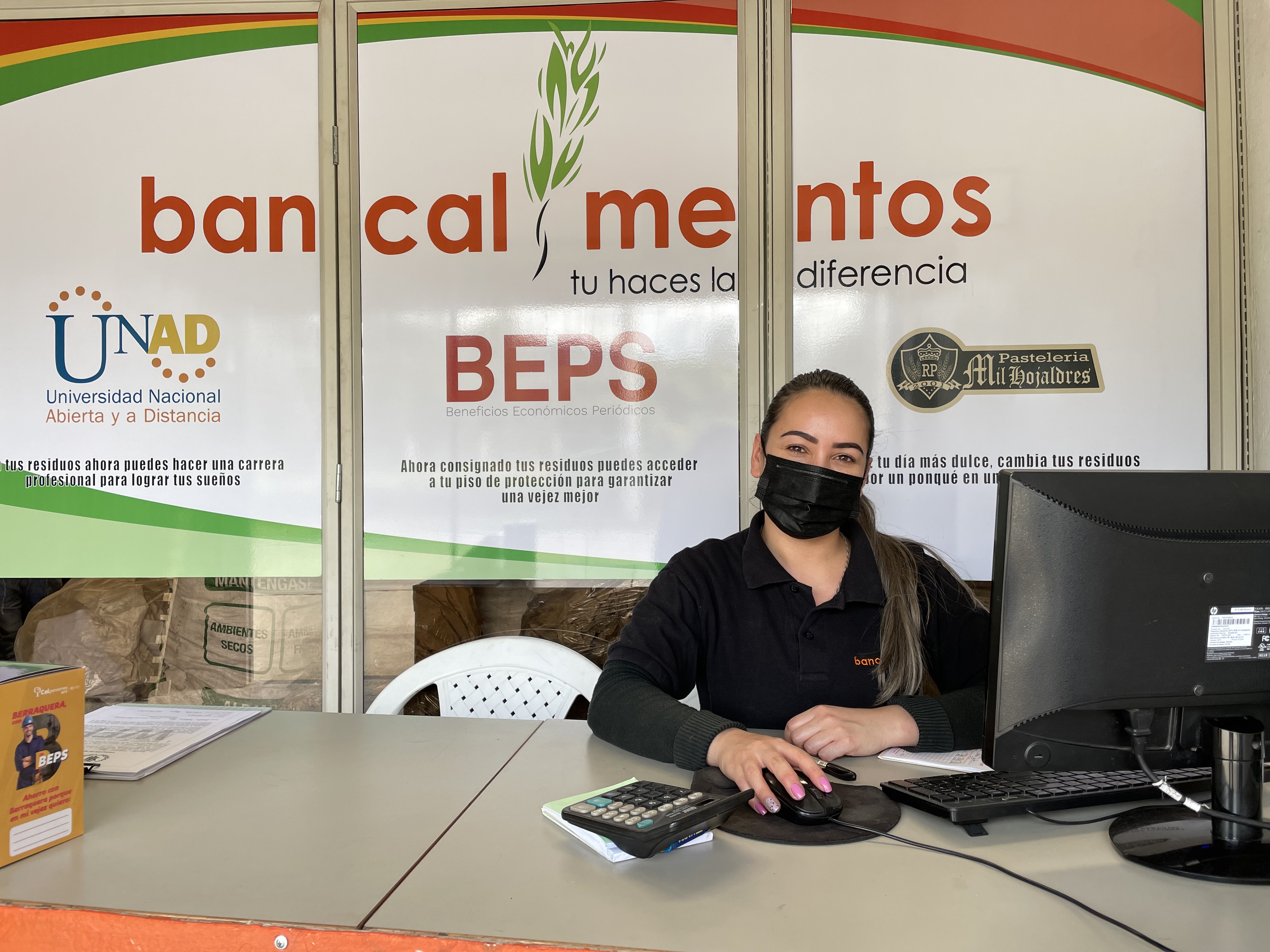 Woman seated behind a desk at the Bancalimentos office; WFP: Photo/Jessika Camargo