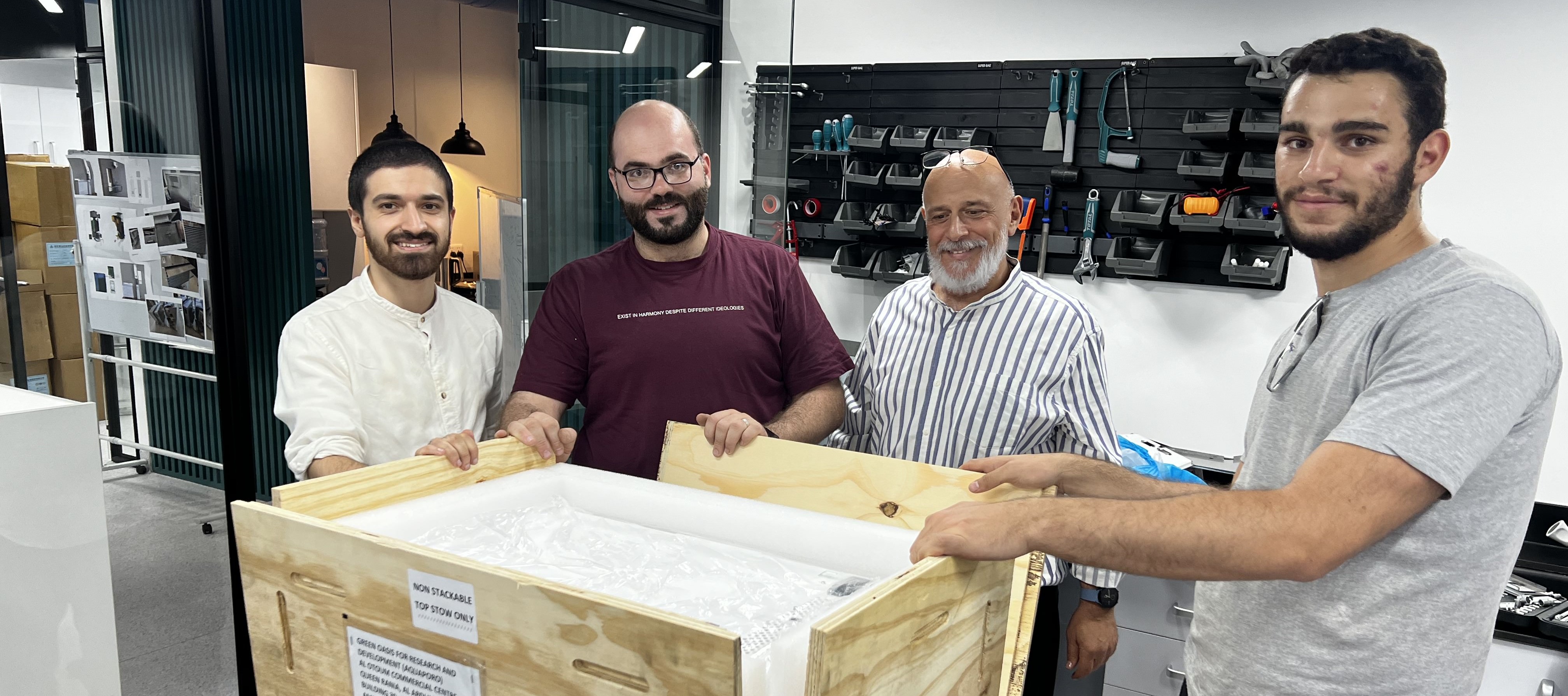 The AquaPoro team (from left to right: Obeida Mudraj, Husam Almassad, Fouad Rihani, and Suhaib BaniHani) unboxes the first manufactured sample of WaHa.