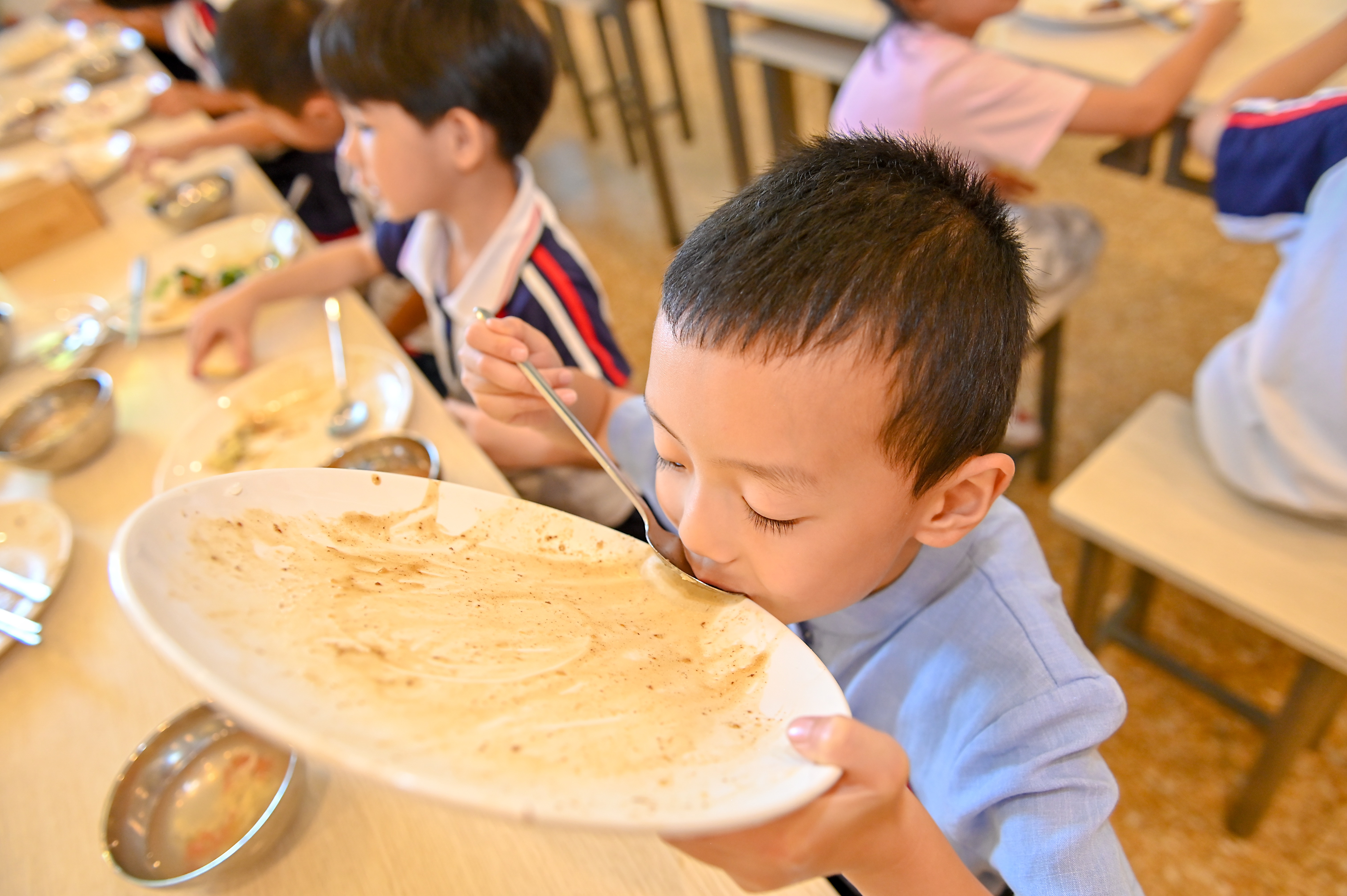 A boy eating from a clean plate; Photo: WFP/Clear Plate