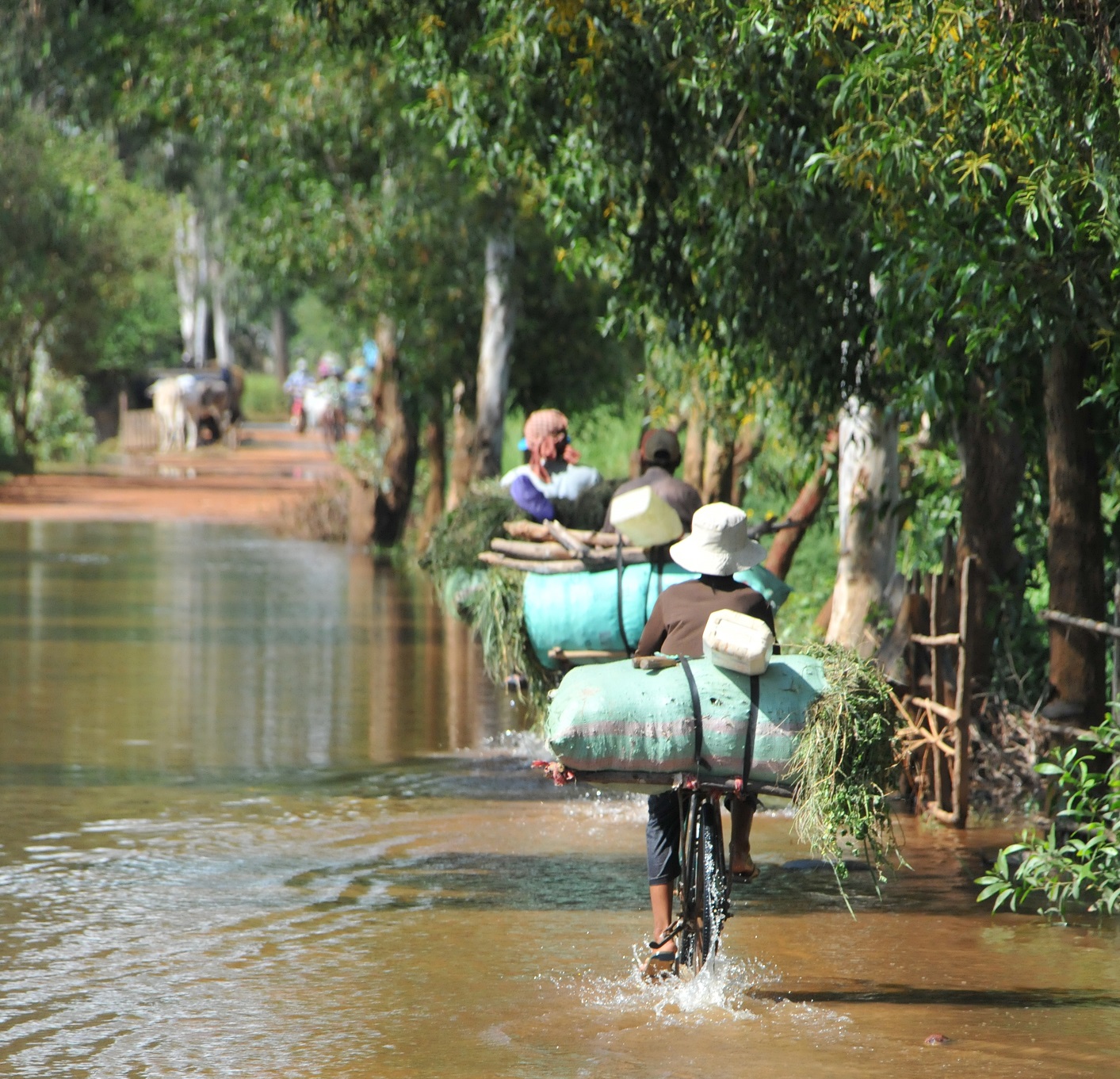 Cylclists in Cambodia Floods