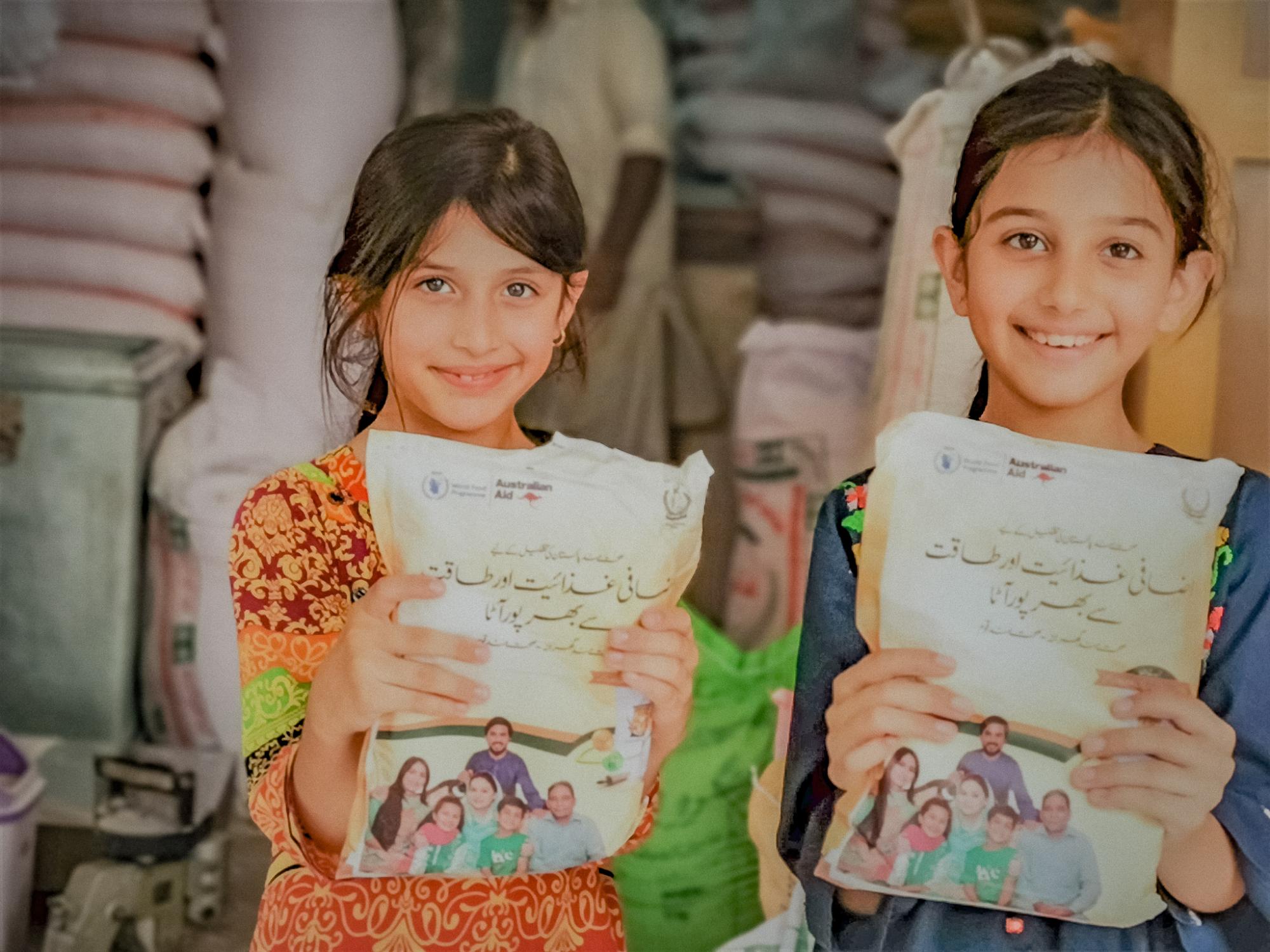 Two girls holding fortified flour