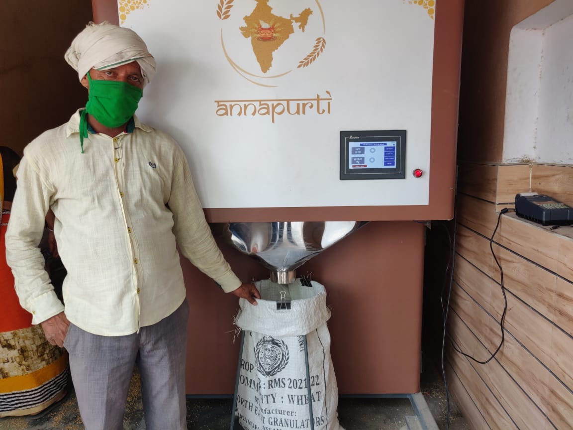 A miller from India stands beside the Annapurti machine. Photo credit: WFP/Piyush Kanal