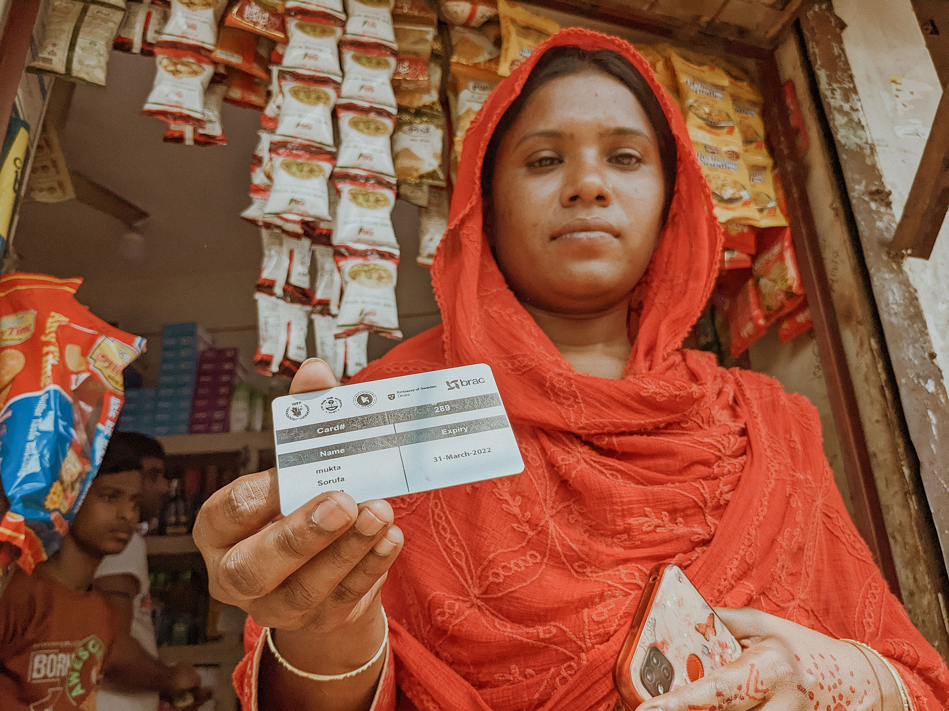 Woman holds her WFP card.