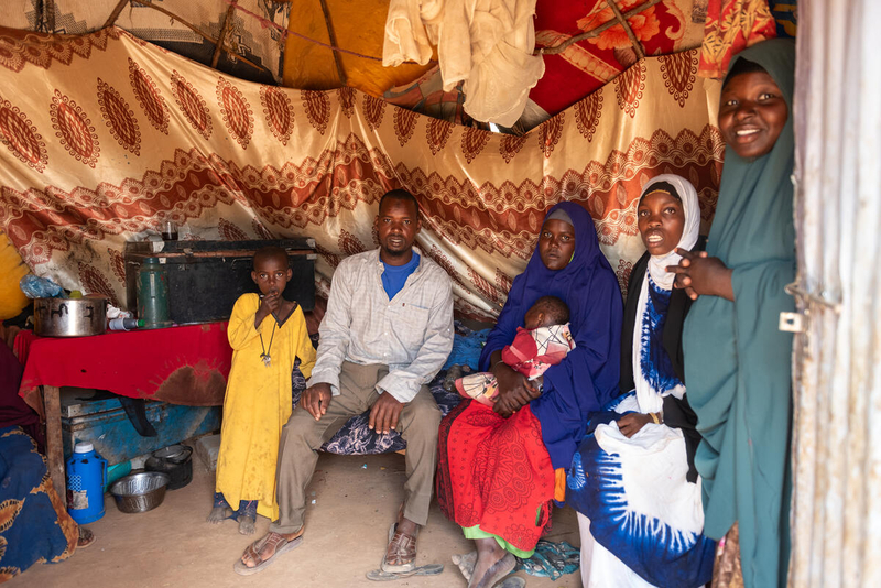 WF1798567_K4D_4930.jpg A newly arrived refugee family poses for a photo in Kenya