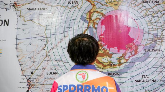 A person looking closely at a map