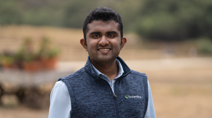 Boomitra founder Aadith Moorthy smiling to camera.