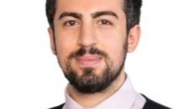 Photo of Servet Avci on a white background smiling to camera.