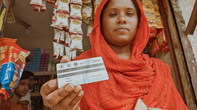 Woman holds her WFP card.