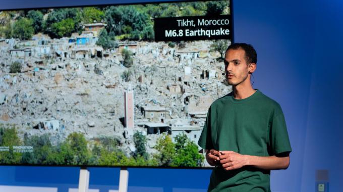 Amine Baha stands in front of a presentation screen at the WFP Innovation Pitch Event in 2025.