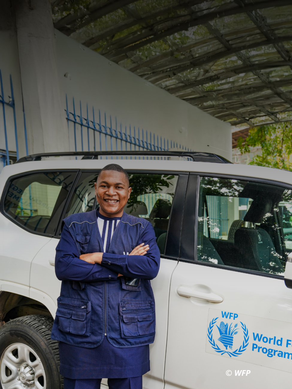 Sedric in front of a WFP car.