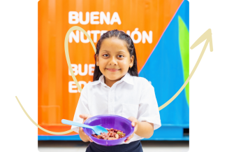 A girl with a cheerful expression holds a bowl of food, set against a Kitchen in a Box container.