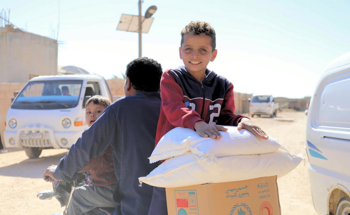 Displaced Syrian families receiving food assistance in Maskaneih city. | Photo: WFP/Marwa Bana