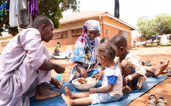 Somalia family sitting and eating lunch in their farm