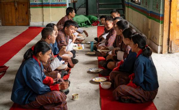 Pupils of Buli Central School enjoying a school meal provided through the Ministry of Education and Skills Development’s National School Feeding and Nutrition Programme. Throughout 2024, WFP supports the ministry with the design of nutritious meals through School Menu Planner (SMP) PLUS tool. © WFP/Rein Skullerud