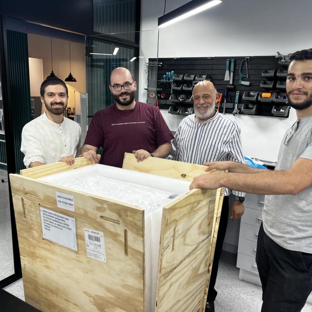 The AquaPoro team (from left to right: Obeida Mudraj, Husam Almassad, Fouad Rihani, and Suhaib BaniHani) unboxes the first manufactured sample of WaHa.