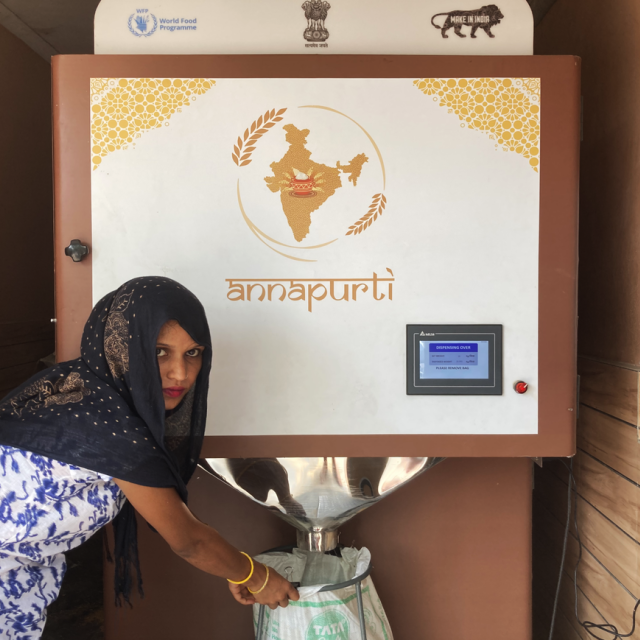 Woman fills bag using GrainATM.