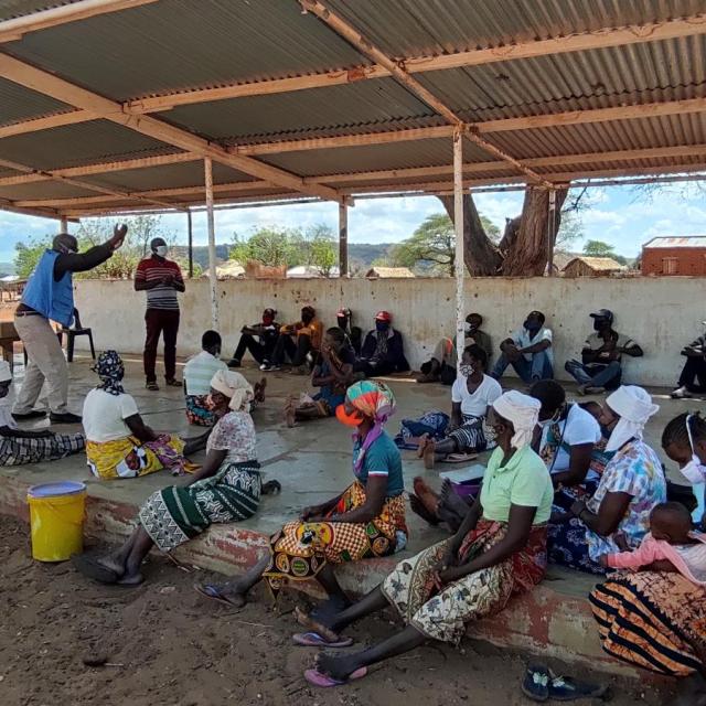 A man speaking to a group of people