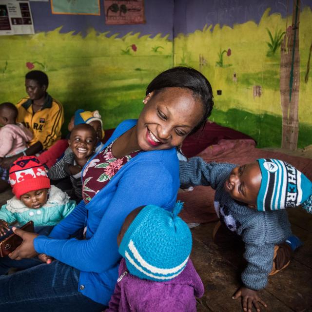 Children and a teacher playing in a community preschool. Photo: WFP/Mia Collis