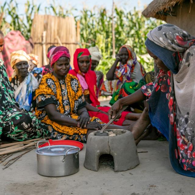 Women using charcoaled briquettes to cook. Charcoaled briquettes replace harmful wood-based charcoal and mitigate deforestation.