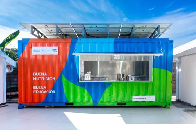 A brightly-colored storage container converted into a kitchen for delivering healthy school meals in El Salvador.