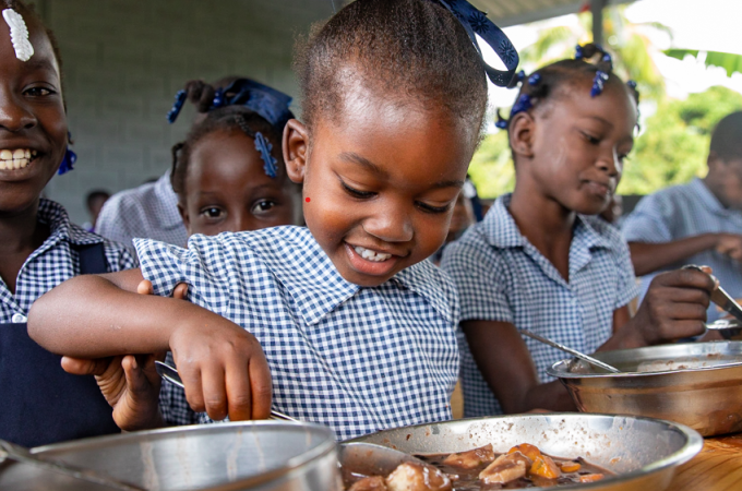 A young student enjoys a school meal. 