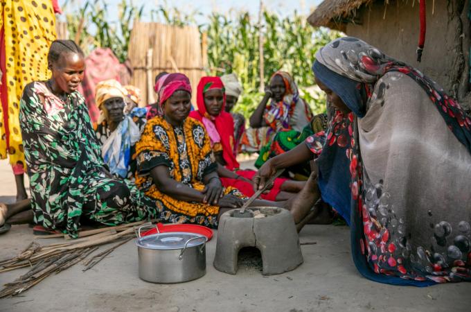 Women using charcoaled briquettes to cook. Charcoaled briquettes replace harmful wood-based charcoal and mitigate deforestation.