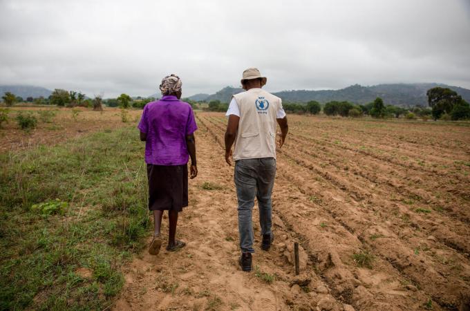 Margret speaks with WFP Communications Associate Tatenda Macheka in her field near her home in Masvingo, Zimbabwe. Photo: WFP/Cynthia Matonhodze